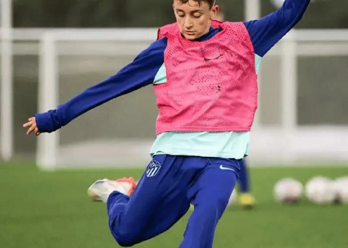 Football player kicking a ball.