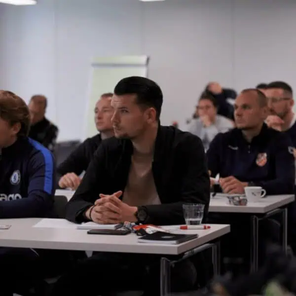 Participating coaches seated during a theoretical session at PSV Eindhoven Interest Days coaching course.