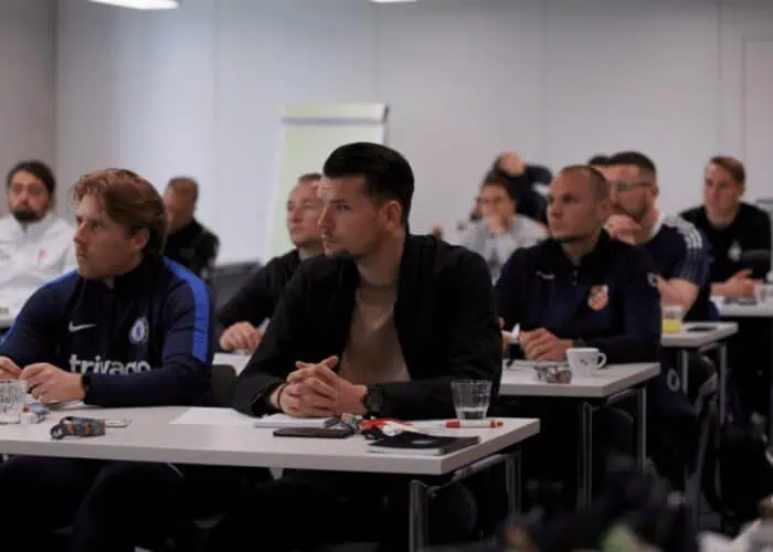 Participating coaches seated during a theoretical session at PSV Eindhoven Interest Days coaching course.