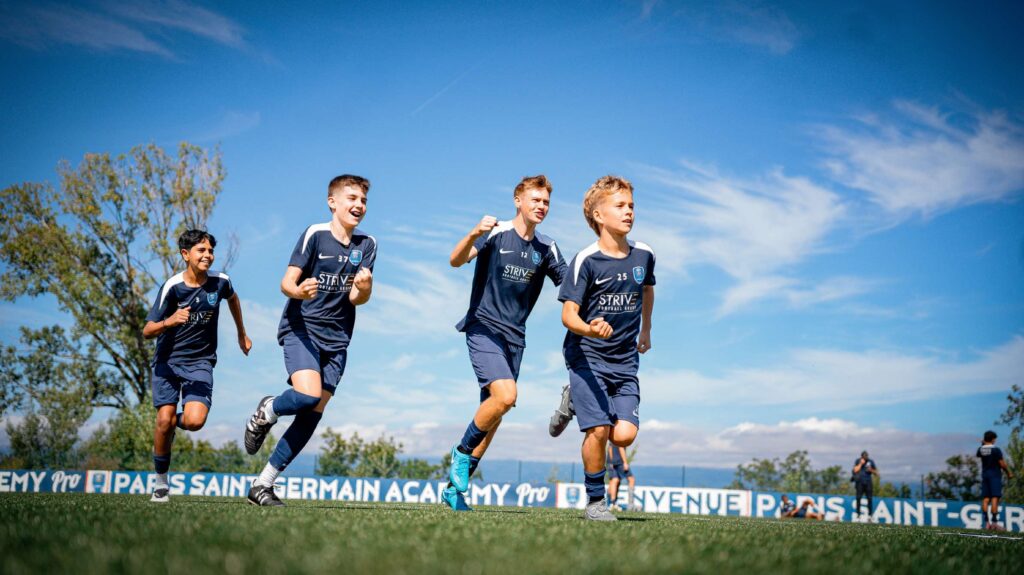 Academy players of Paris Saint Germain Football Boarding School running on the football pitch in Evian, France.